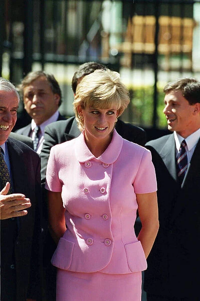 PRINCESS DIANA, WEARING PINK SUIT AND SMILING, GREETING PEOPLE ON HER TRIP TO ARGENTINA