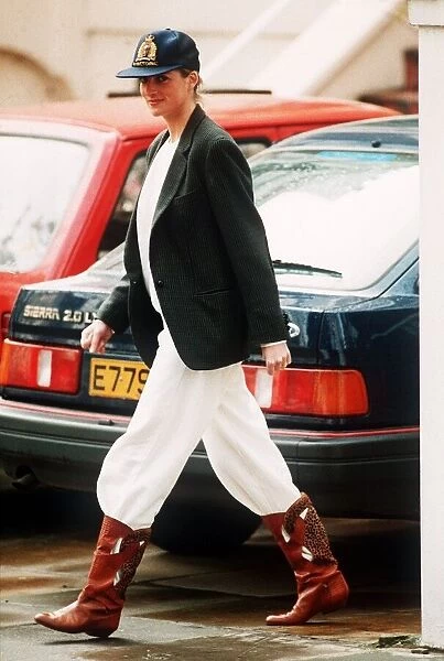 Princess Diana wearing an unusual combination of white trousers, boots