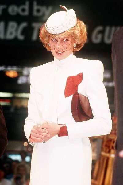 Princess Diana, wearing a white ensemble with red accents