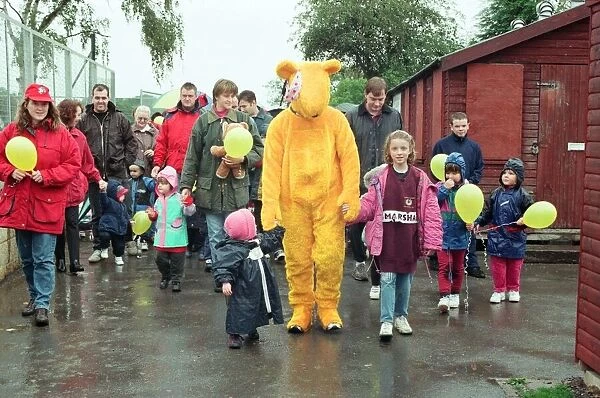 Pudsey Bear leads the toddlers round the park during the Great Toddle for Children in