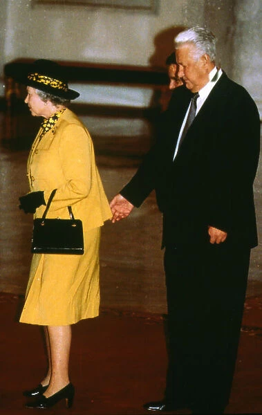 Queen Elizabeth with Boris Yeltsin standing behind and appearing to pinch the monarch