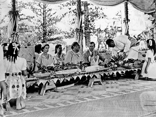 Queen Elizabeth II and Prince Philip with the Queen of Tonga at a feast at which a
