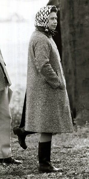 Queen Elizabeth II standing on one leg looking silly wearing wellies June 1980