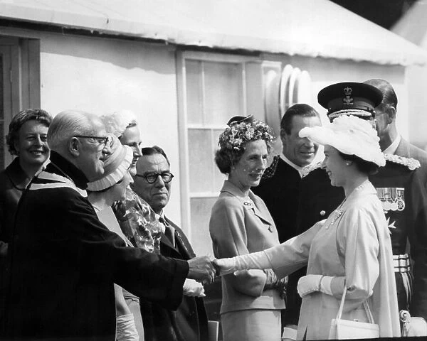 Queen Elizabeth II visiting Wales. The Queen shakes hands with Mr T W Thomas