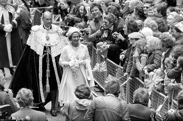 Queen Elizabeth II waving at the crowd during their Silver Jubilee celebrations