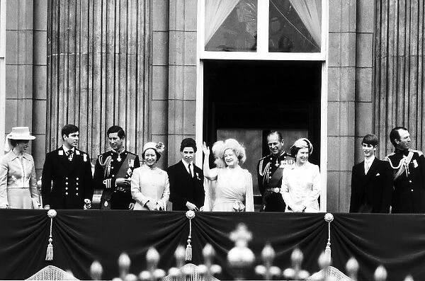 Queen Mother waving to the crowds from the balcony at Buckingham Palace following a