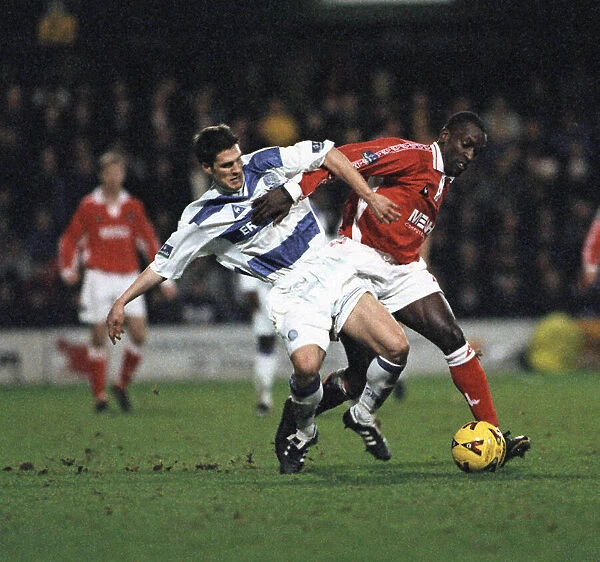 Queens Park Rangers defender tackles Charlton forward during the Queens Park Rangers v