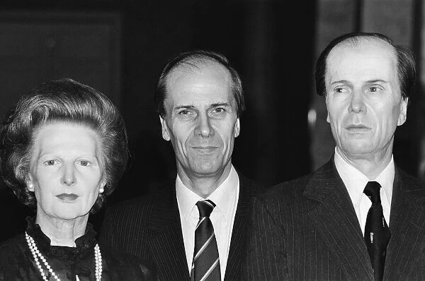 The real Norman Tebbit stands with wax works of Mrs Thatcher
