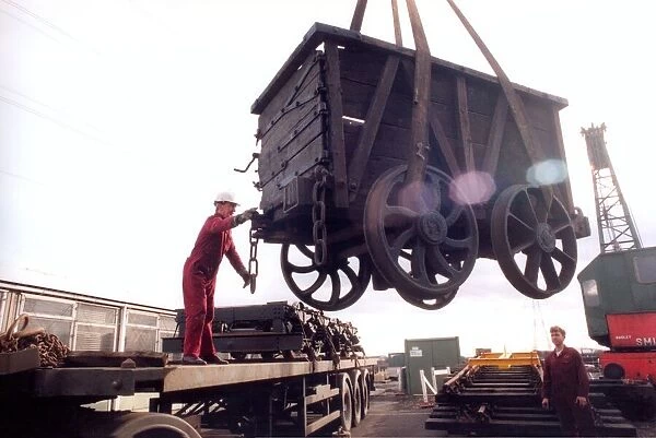 Restoration engineer Grodon Stark, on the flat bed is helping to move an anciet wagon at