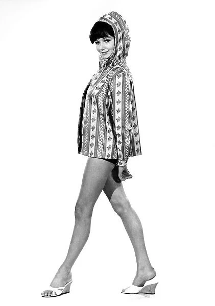 Reveille Fashions 1964: Meriel Weston modeling a hooded beach jacket. April 1964 P007619