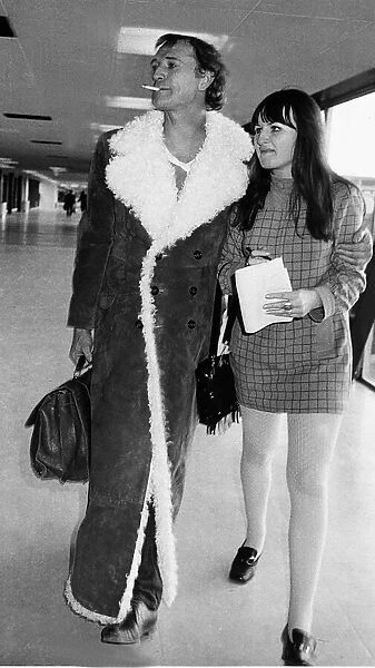 Richard Harris Irish actor at Heathrow airport 1970 with arm around female