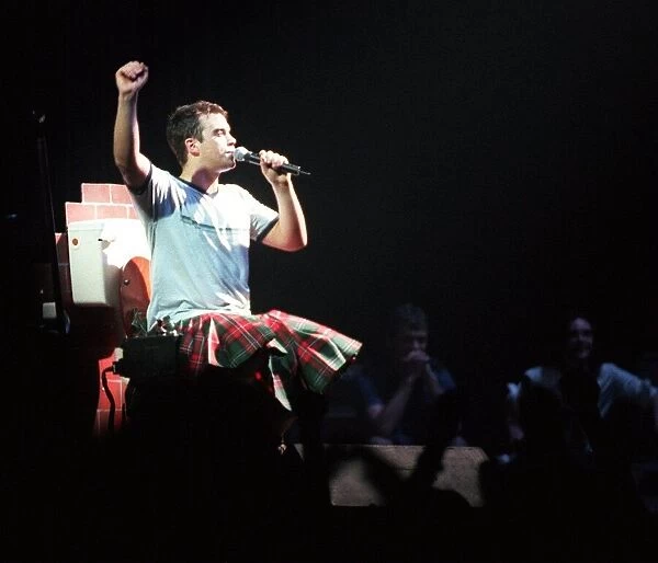 Robbie Williams wearing kilt sitting on toilet February 1999 during SECC concert Glasgow