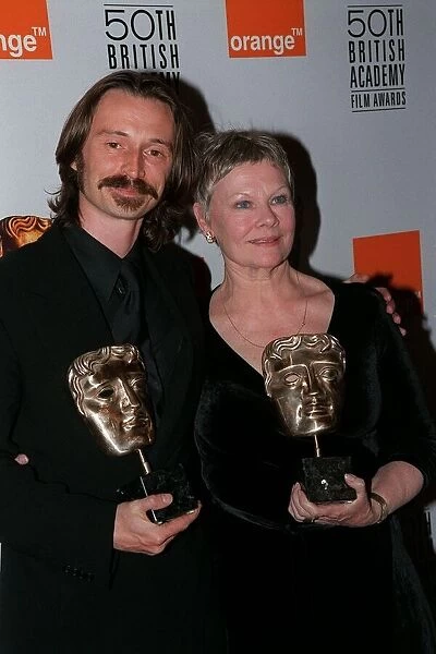Robert Carlyle Actor April 98 Atthe BAFTA awards with Judi Dench both holding bafta