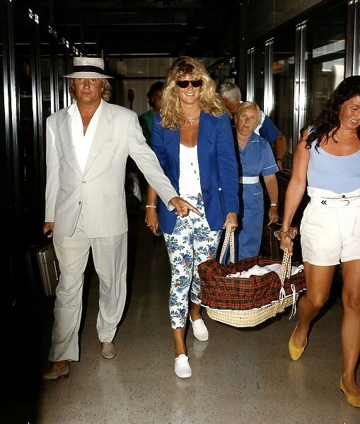 Rod Stewart and Rachel Hunter carring baby Renee arriving at Airport
