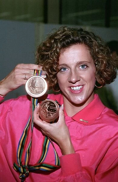 SALLY GUNNEL HOLDING HER GOLD AND BRONZE MEDALS WON AT THE 1992 OLYMPICS ON RETURN TO