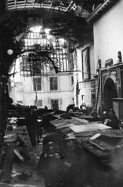 Salvage workers shift through the wreckage the Guildhall after a direct hit