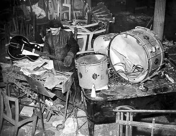 Salvage workers sort through the damaged band instruments at the Cafe de Paris following