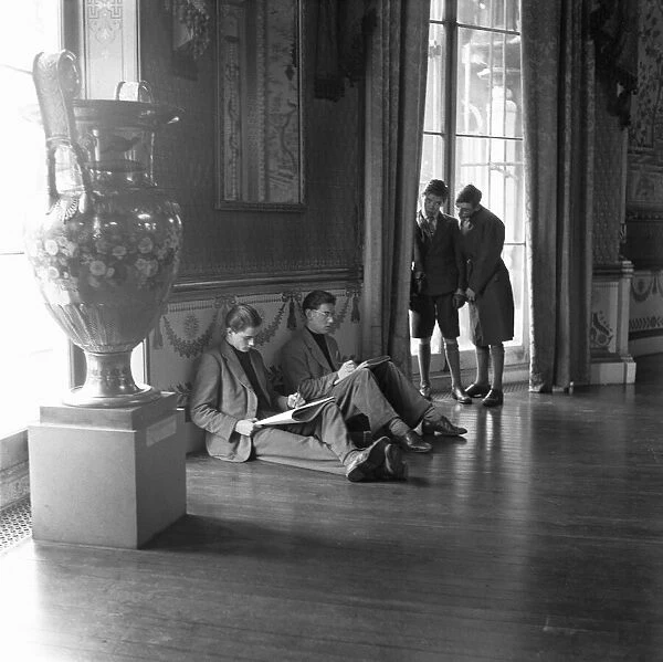 Two schoolboys look on as artists sketch in the public library in the Pavilion in