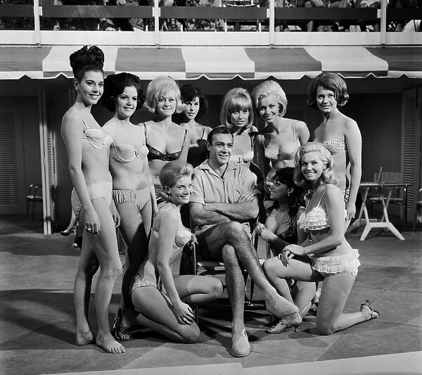 Sean Connery surrounded by the cast of girls who will appear in the latest James Bond