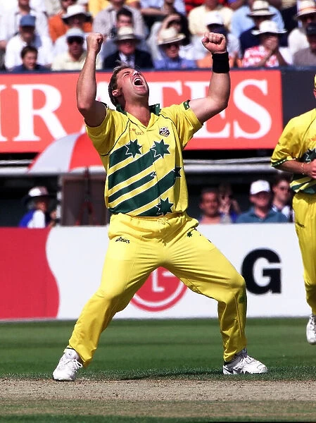 Shane Warne of Australia celebrates after taking a wicket against South Africa in