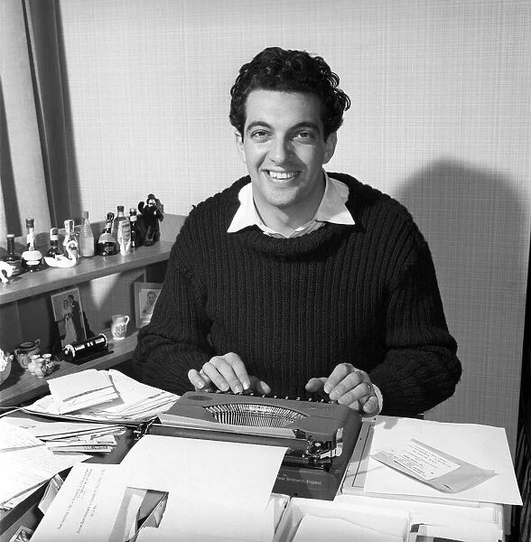 Singer Frankie Vaughan seen here at the typewriter answering some of his fan mail