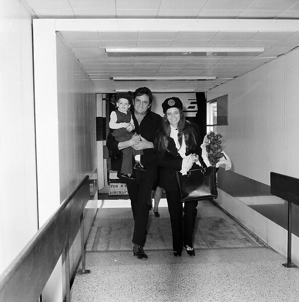 Singer Johnny Cash arrives at Heathrow Airport from Manchester with his wife June Carter