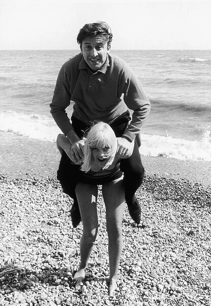 Singer Vince Hill seen here playing on the beach at Brighton with TV presenter Anne