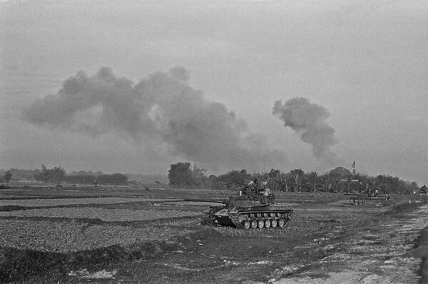 Smoke rising in the distance as armoured units of the South Vietnamese army shell Viet