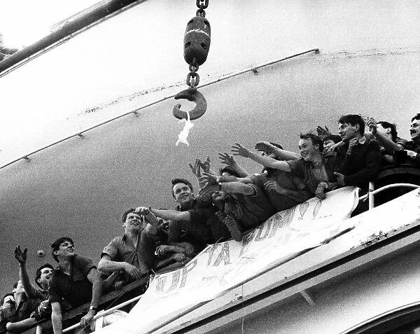 Soldiers aboard the QE2 reaching out for a bra that is up for grabs belonging to a Lance