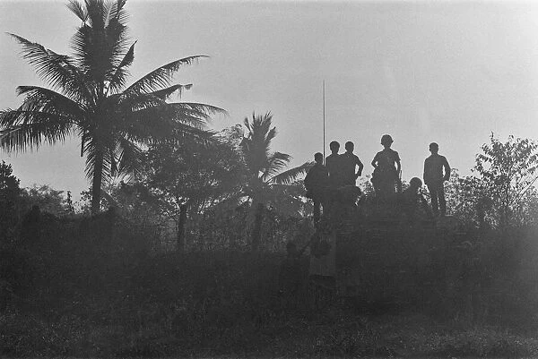Soldiers of the South Vietnamese army watch from the top of an armoured personnel carrier