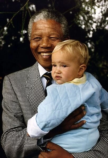 South Africas President Nelson Mandela with a young white boy