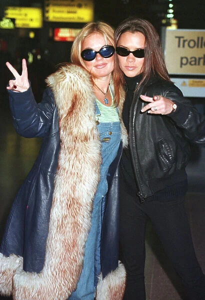 Spice Girls Geri Halliwell (L) and Victoria Adams (R) leaving Heathrow for Toronto