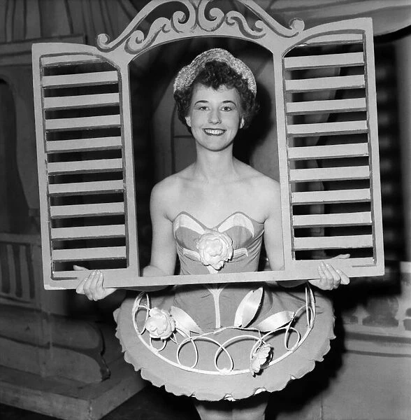 And through the square window. Chorus girl holding window frame
