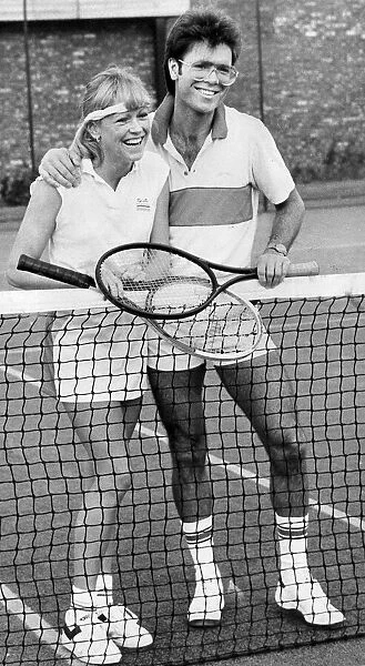Sue Barker and Cliff Richard laughing during tennis match - October 1983