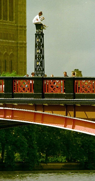 Suicide attempt on Lambeth bridge a woman attempting suicide sits on top of a light over