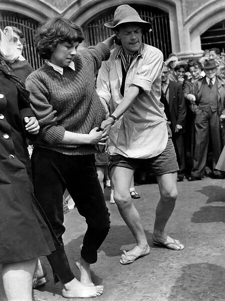 Terry Gray, aged 20 of Crookham, Hants, in shirt and sandals dances with Ann Buckridge of