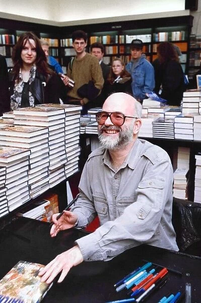 Terry Pratchett, an English author of fantasy novels, signing copies of his book