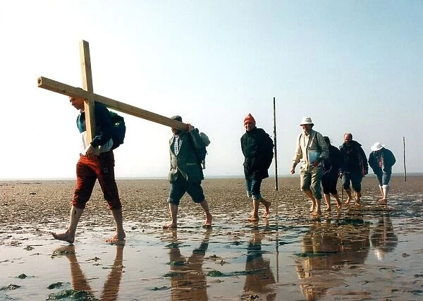 Tim cooke, far left, leads the group from Hexham, across the causeway at Holy Island