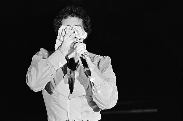 Tom Jones in concert in America. Tom wipes his face on a pair of knickers. April 1983