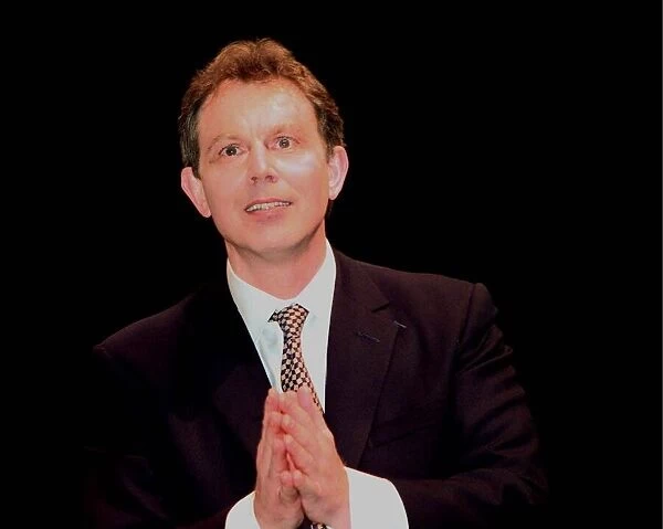 Tony Blair Labour Party leader looking as if he is praying
