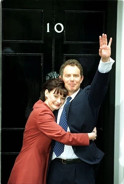 Tony Blair and wife Cherie stand at the door of 10 Downing Street waving to the crowd