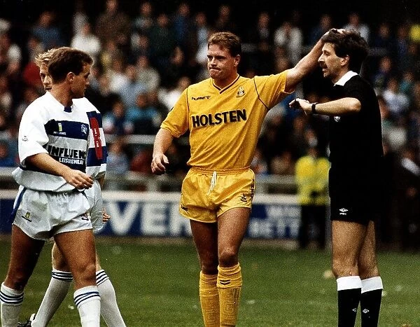 Tottenham Hotspur footballer Paul Gascoigne pats the referee on the head during a match