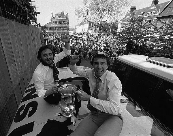 Trevor Brooking and Frank Lampard hold the FA Cup on top of the parade coach on arriving