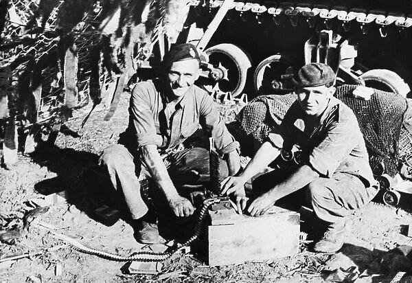 Trooper F. Willis and Lance Corporal T. A. Jones load ammunition into their tanks machine