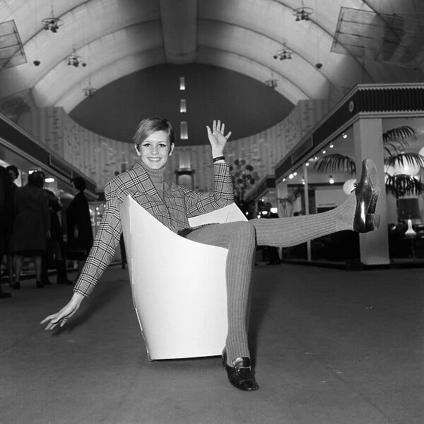 Twiggy sitting in a paper chair at the Ideal Home Exhibition. 6th March 1967