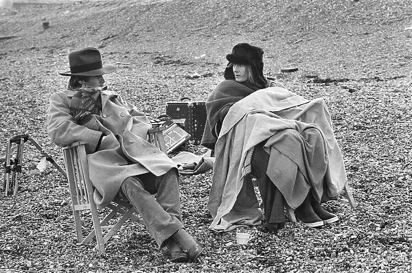 Vanessa Redgrave and James Fox sit in their cast chairs on the pebbled beach at Dover