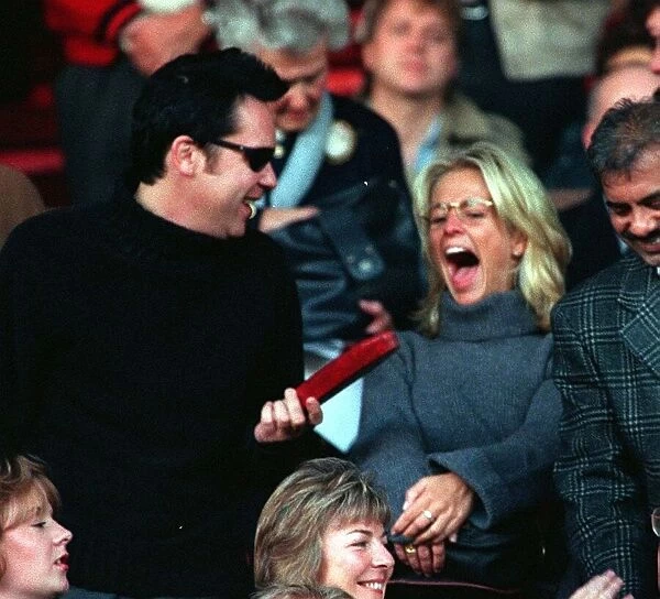 Vic Reeves and Ulrika Jonsson TV Presenter sitting in the stands at Old Trafford to watch