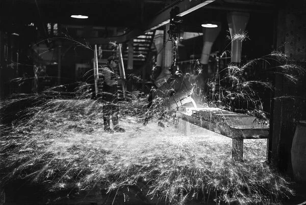 A worker casts components from molten metal at the new one million pound furnace at
