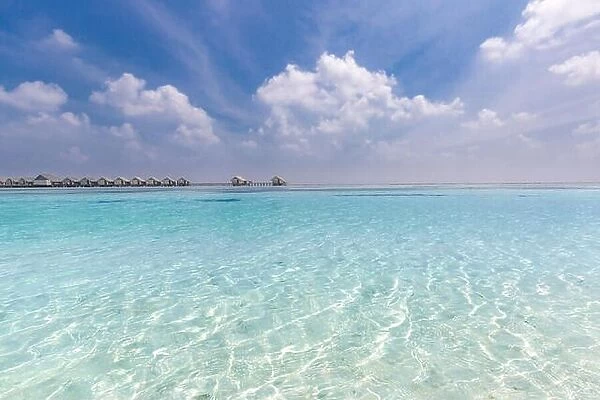 Amazing beach scene in Maldives island. Tropical sea and luxury over water bungalows