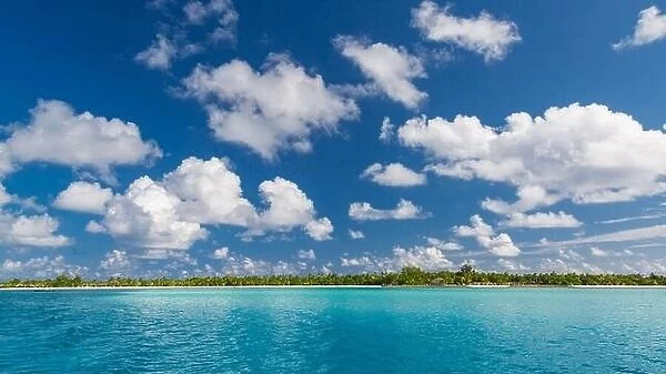 Beautiful Maldivian atoll with white beach seen from the sea. Tropical lagoon and island paradise